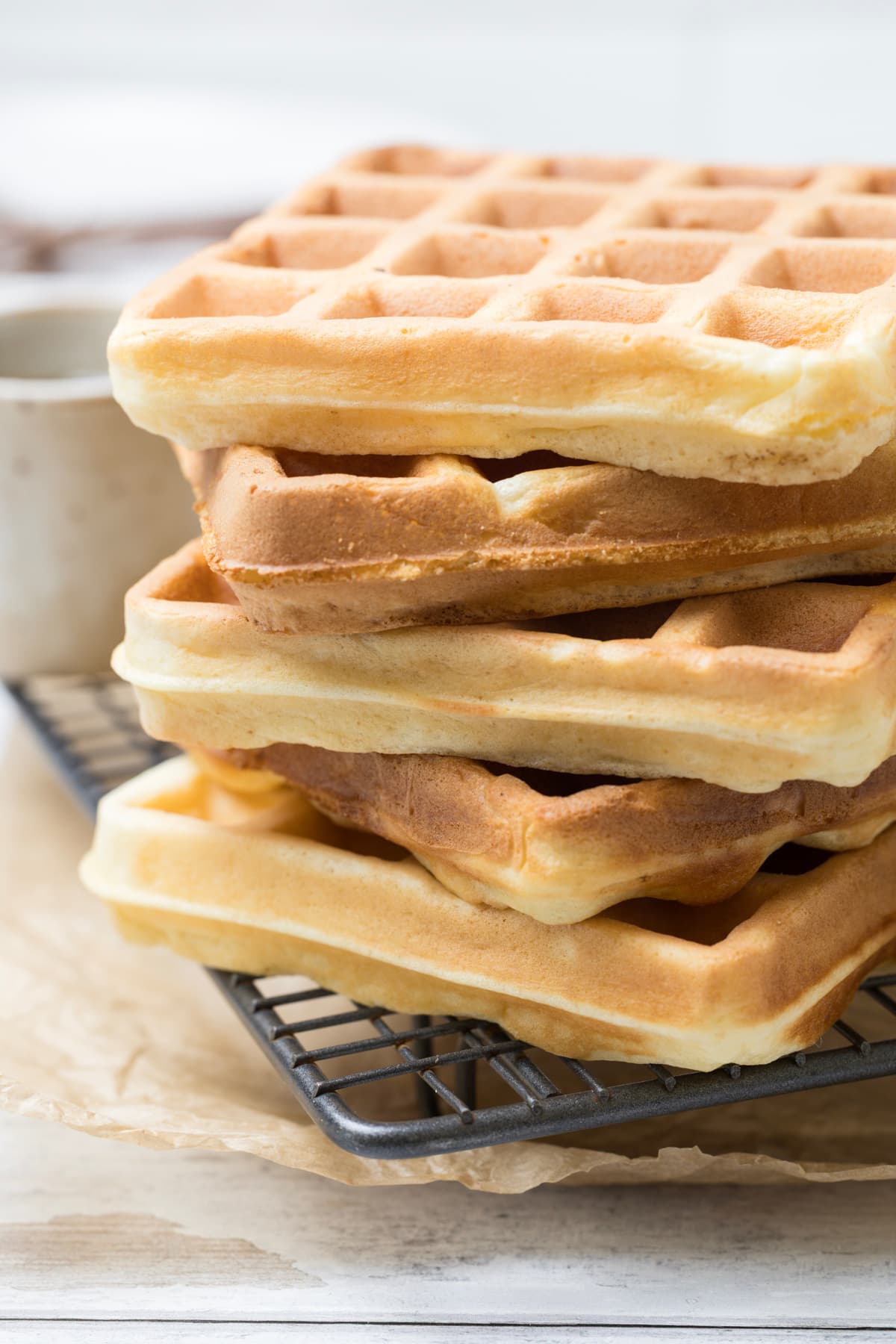 Side view of stacked sourdough discard waffles showing crisp golden edges and fluffy centers.