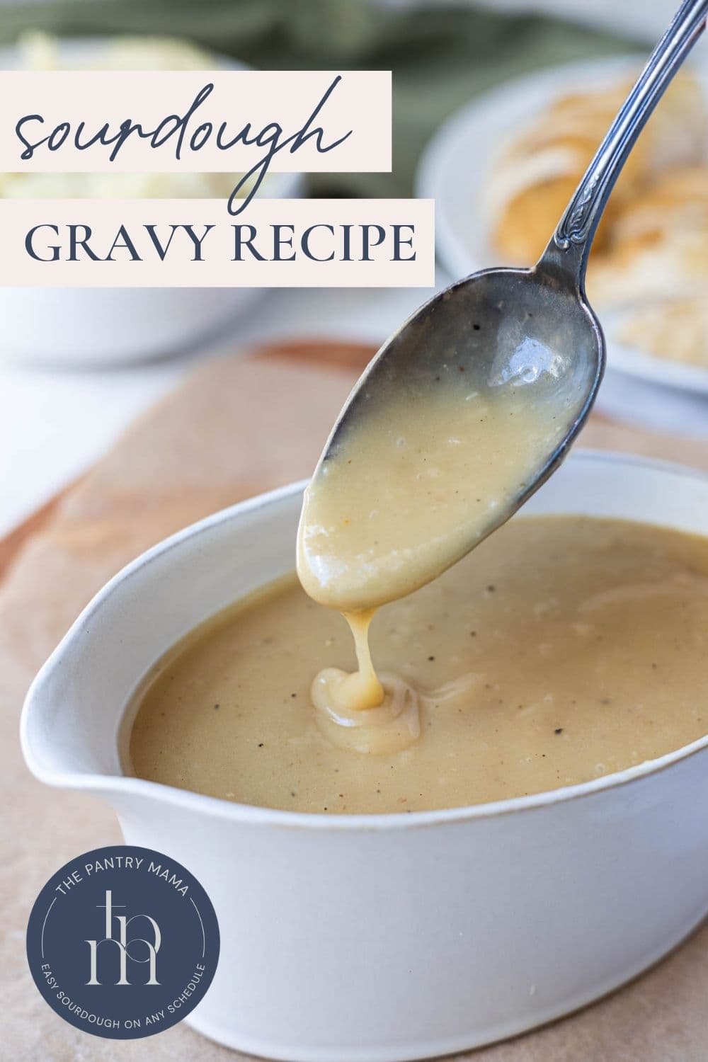 Pinterest graphic for sourdough gravy recipe with creamy gravy dripping from a spoon.