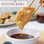 Pinterest graphic for sourdough potstickers with crispy dumpling being dipped in spicy dipping sauce.