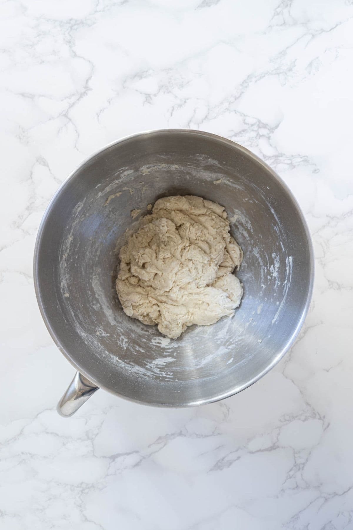 Shaggy sourdough potsticker dough resting in a mixing bowl.