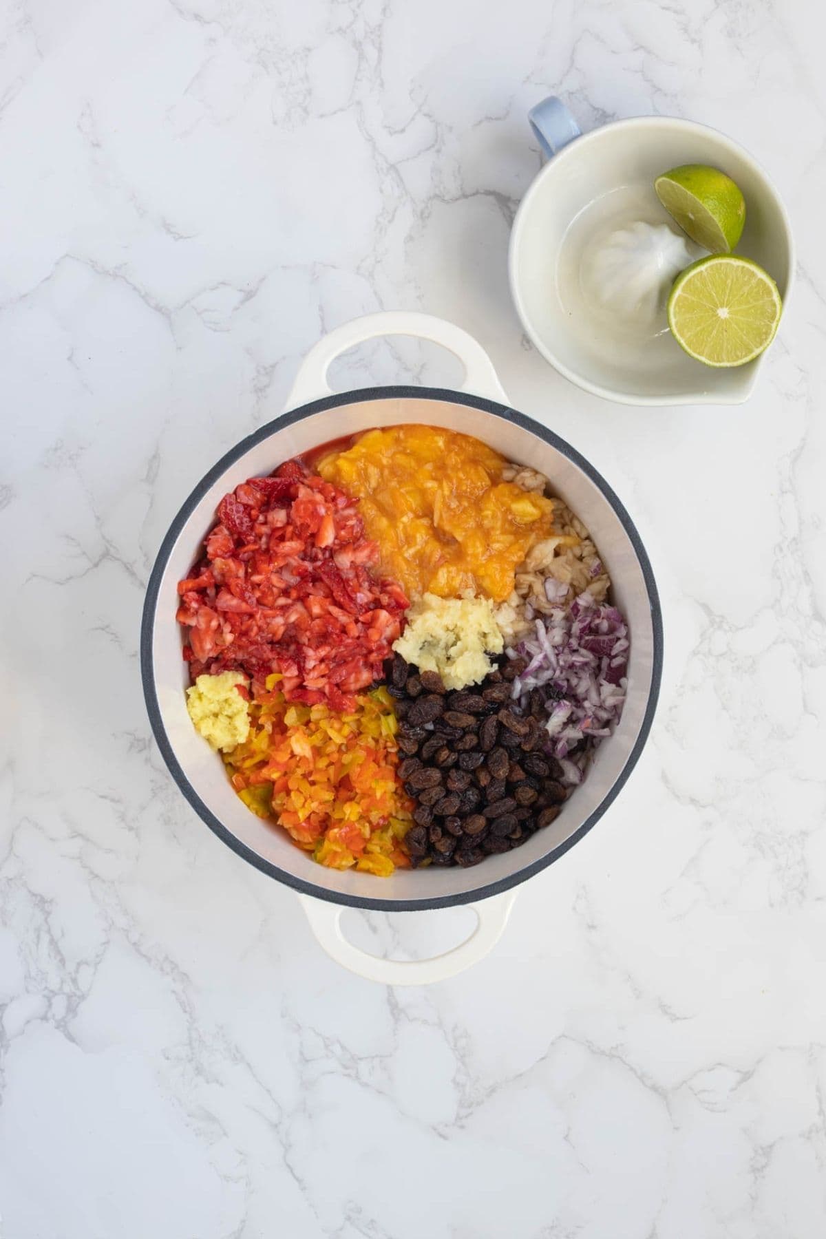 Fresh chopped fruits and vegetables for summer fruits relish in a pot to be cooked.