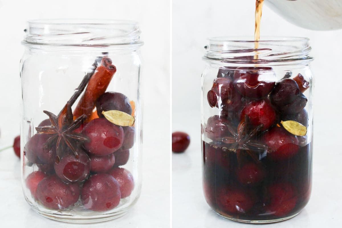 Pouring warm spiced pickling brine over fresh cherries in a glass jar.