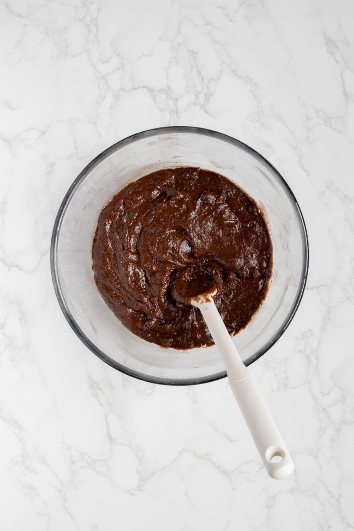 Chocolate brownie batter mixed in a bowl for sourdough chocolate brownie bites.