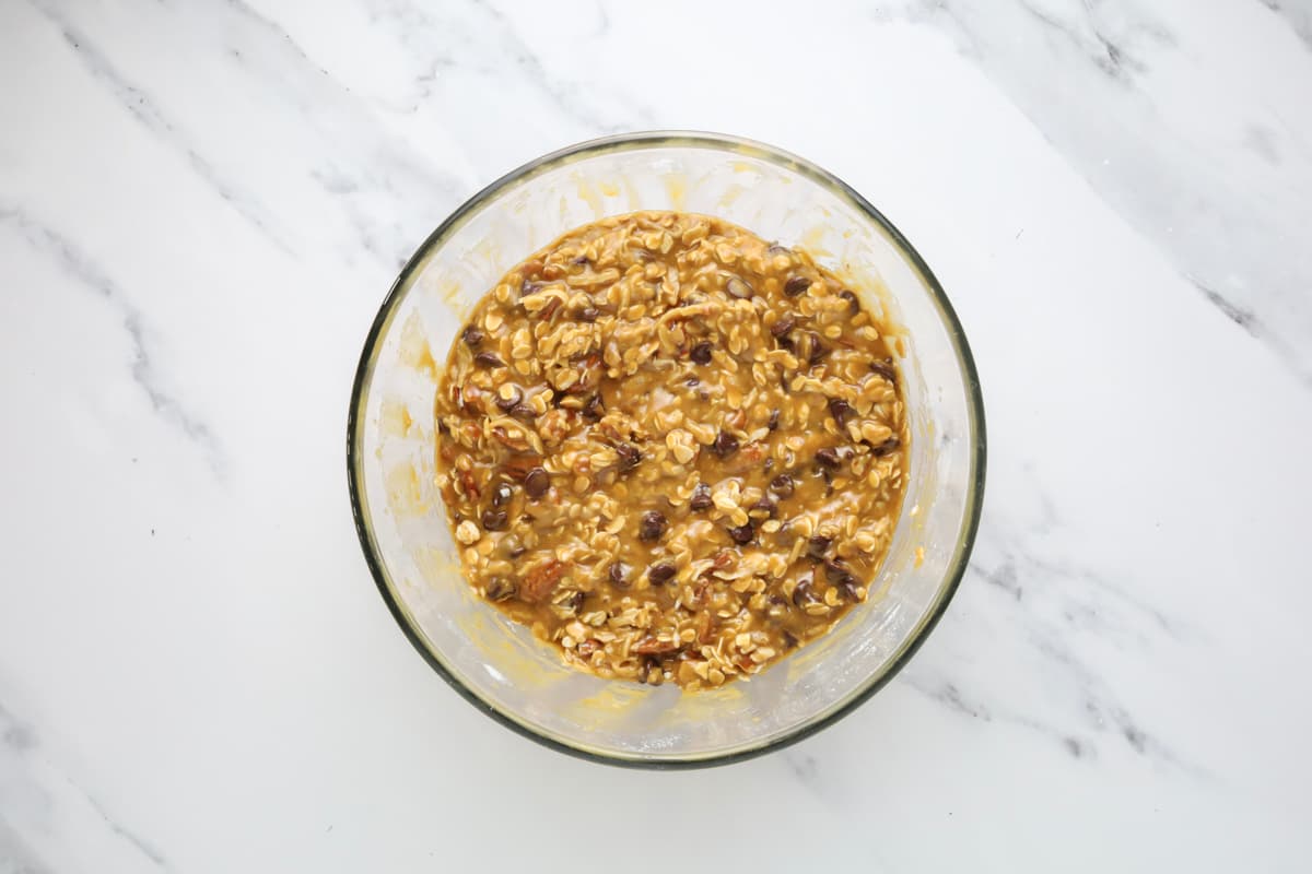 Sourdough cowboy cookie dough mixed in a bowl before scooping onto cookie sheet.