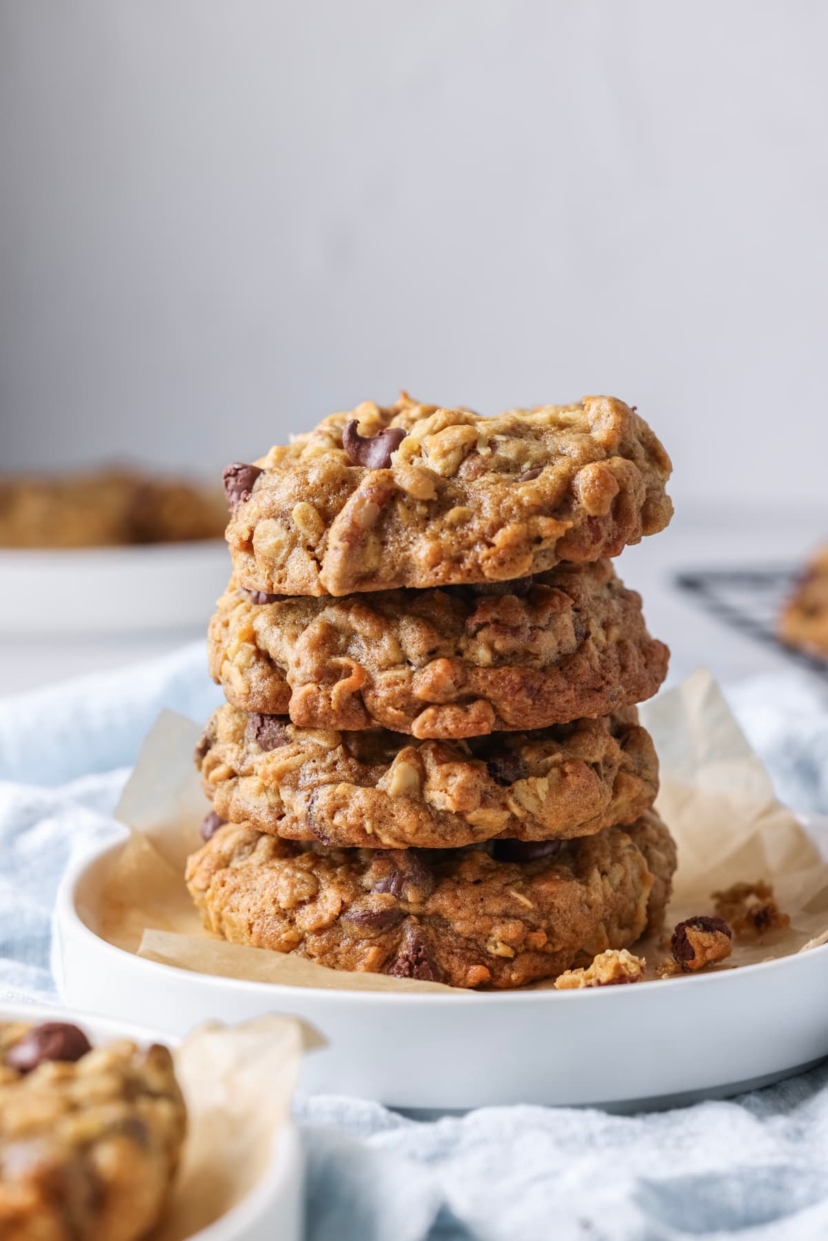 Stack of four homemade sourdough cowboy cookies on a serving plate.
