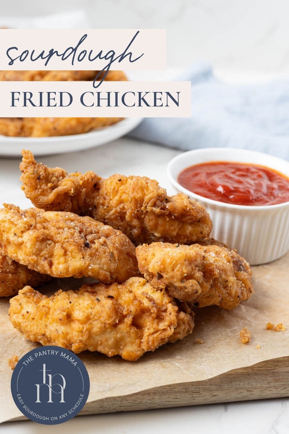 Crispy homemade sourdough fried chicken served with ketchup and text overlay reading "Sourdough Fried Chicken."