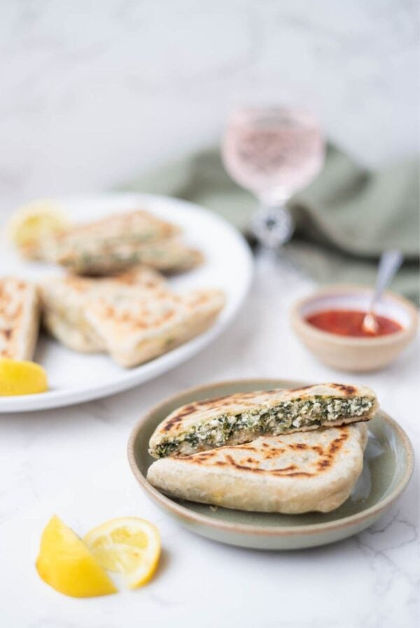 Sourdough gozleme cut open to reveal a savory spinach and feta cheese filling.