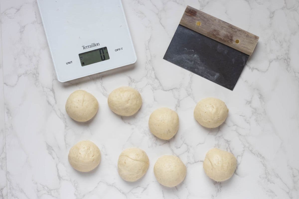 Sourdough gozleme dough divided into equal portions before shaping and filling.