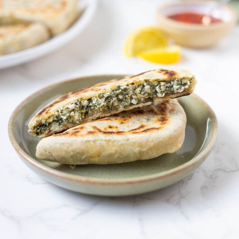 Sourdough gozleme with spinach and feta filling cut open to show the inside.