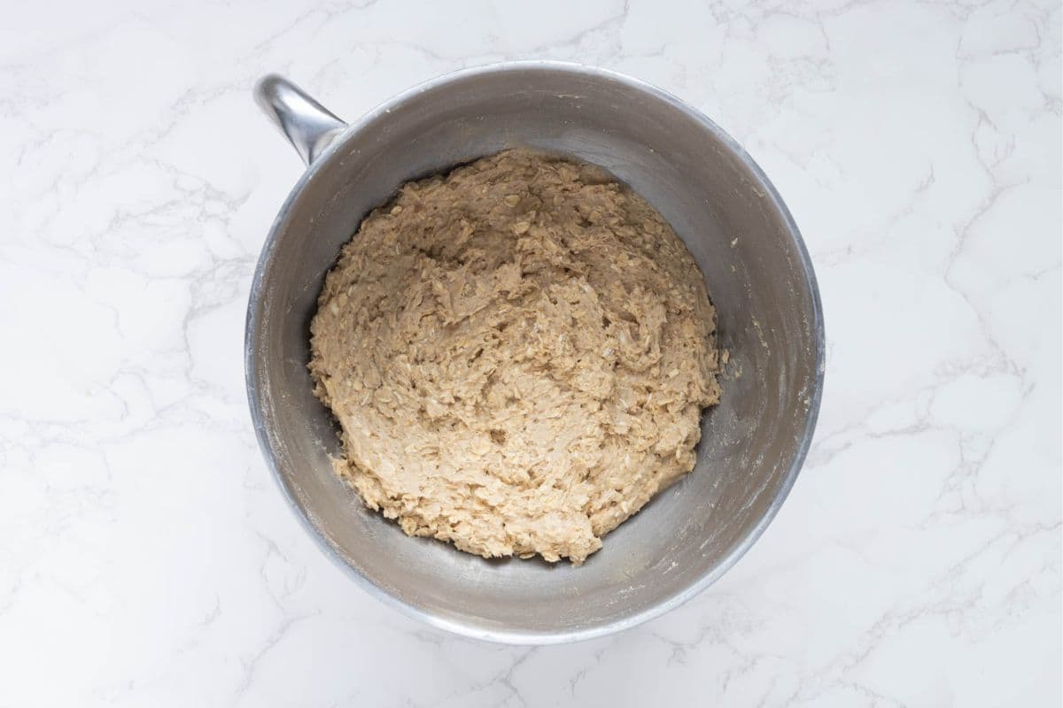 Bowl of mixed sourdough oatmeal cookie dough ready for scooping.