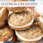Several sourdough oatmeal cream pies stacked together with text overlay reading "Sourdough Oatmeal Cream Pies."