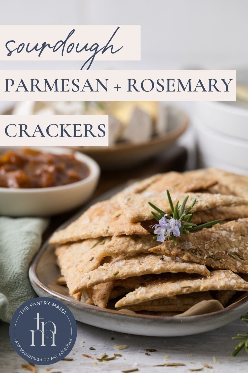 Crispy sourdough discard crackers flavored with parmesan cheese and fresh rosemary with text overlay for a Pinterest pin image.