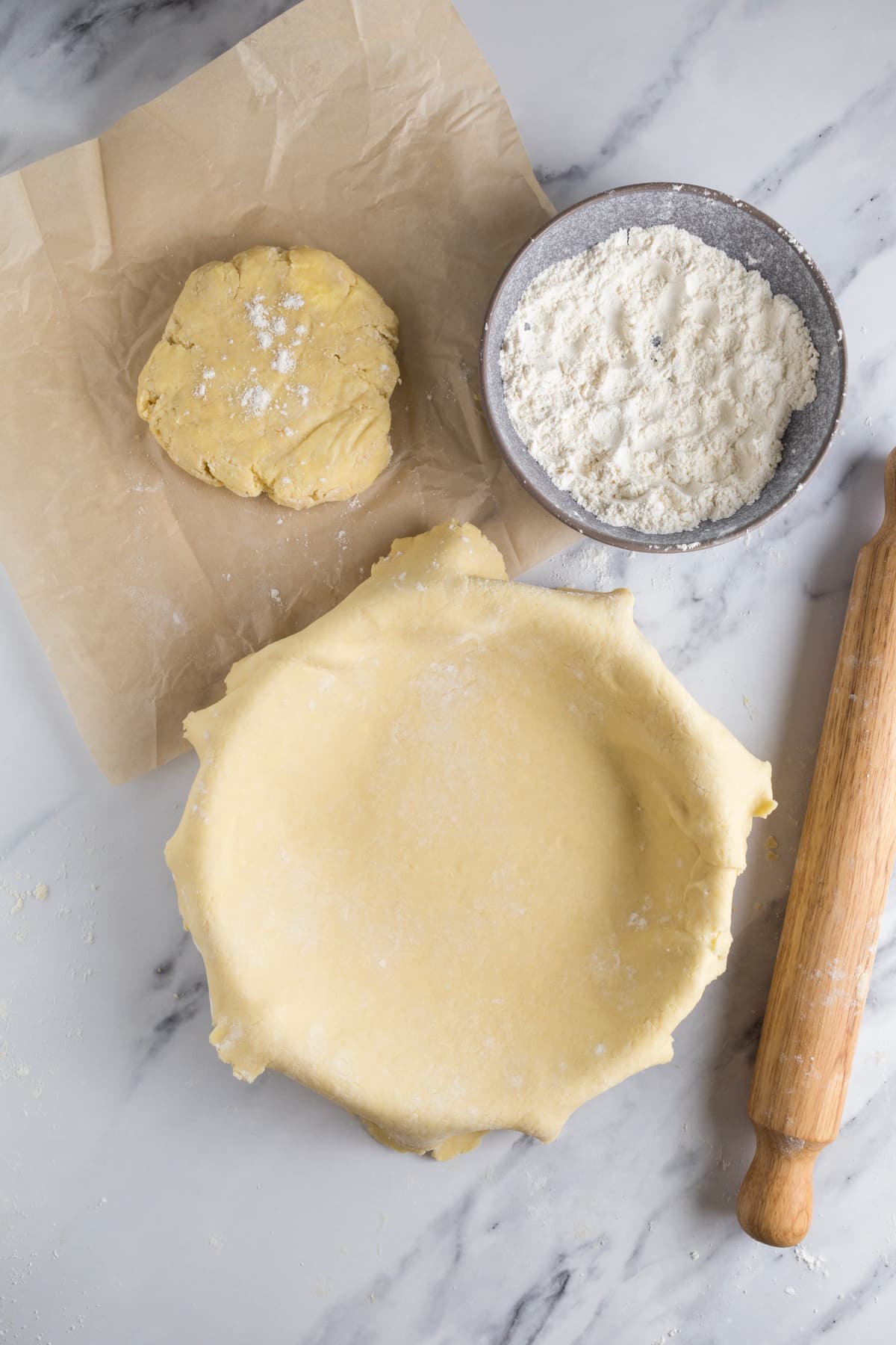 Sourdough pie crust dough rolled out and placed over a pie pan ready to add filling.