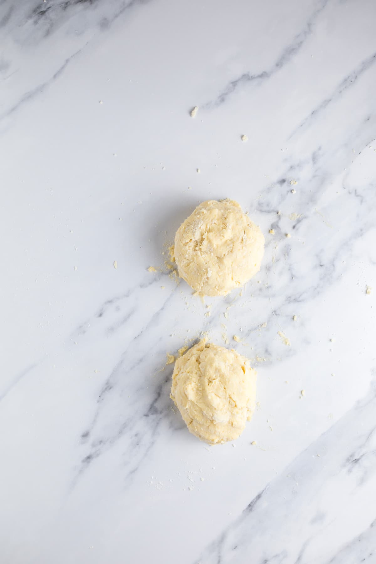 Two portions of sourdough pie crust dough divided before chilling.