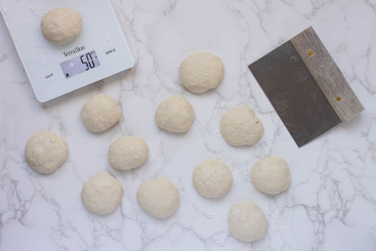 Sourdough pizza dough divided into evenly sized portions ready for shaping into pizza pockets.