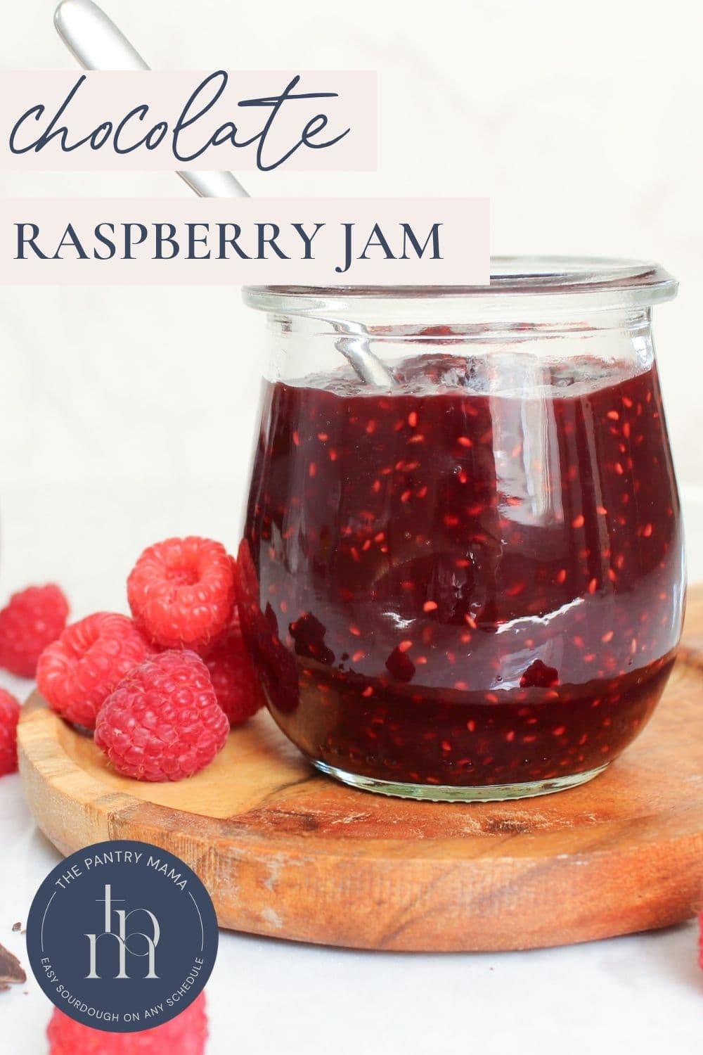 Homemade chocolate raspberry jam made with fresh raspberries and dark chocolate in a glass jar.