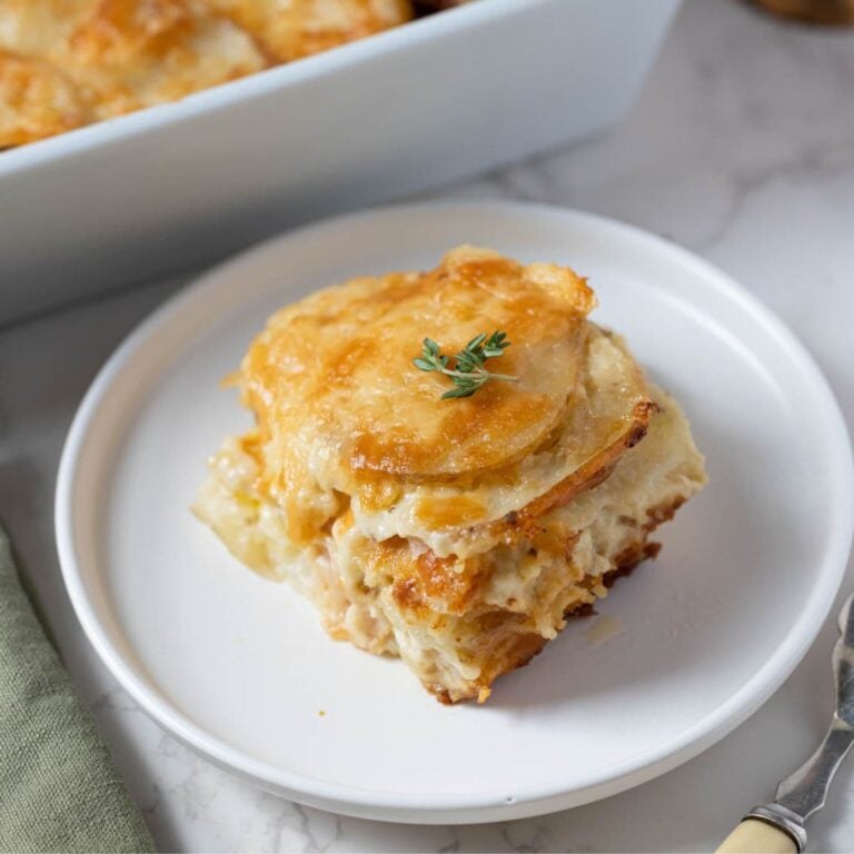 Close up of freshly baked sourdough au gratin potatoes served on a plate.
