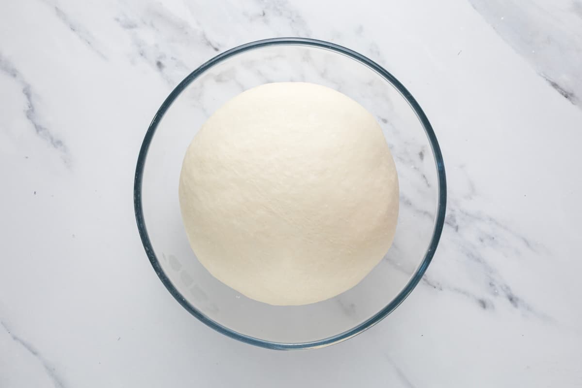 Smooth sourdough bagel dough after bulk fermentation, ready to be divided and shaped.