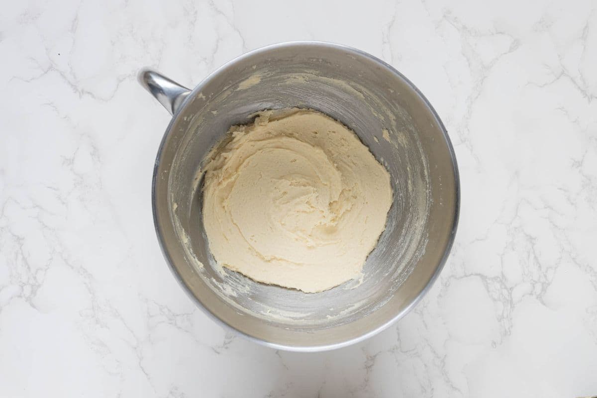 Butter and sugar creamed together in a stand mixer bowl for sourdough chocolate snickerdoodle cookies.