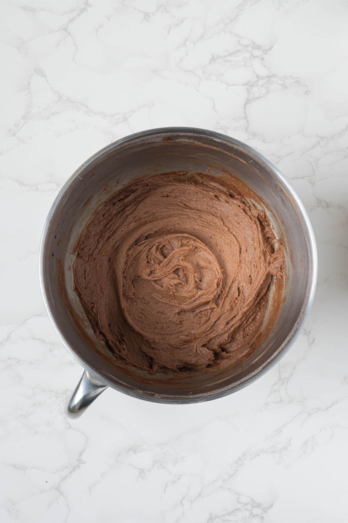 Finished sourdough chocolate snickerdoodle cookie dough mixed in a stand mixer bowl.