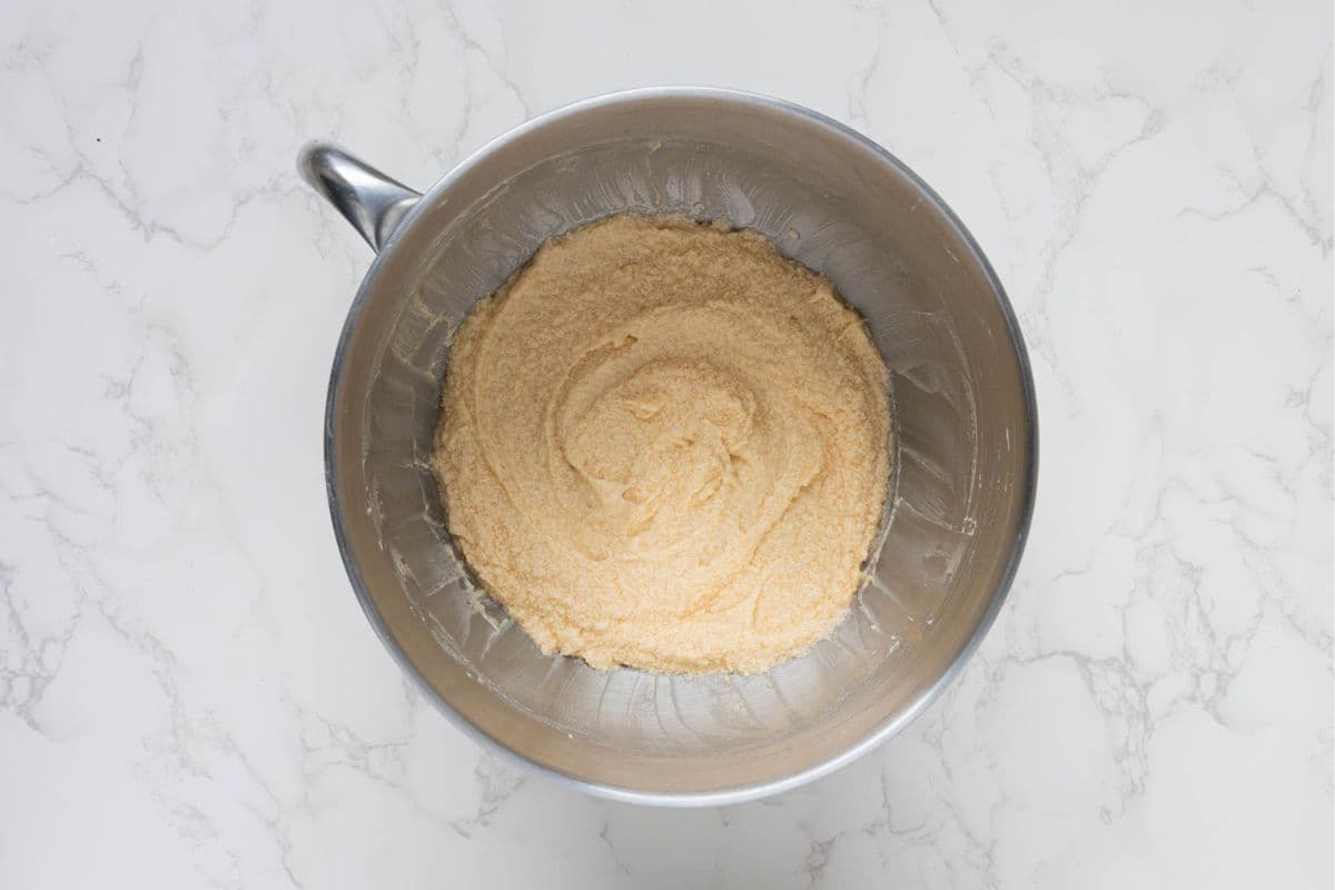 Wet ingredients mixed together in a stand mixer bowl for sourdough chocolate snickerdoodle cookies.