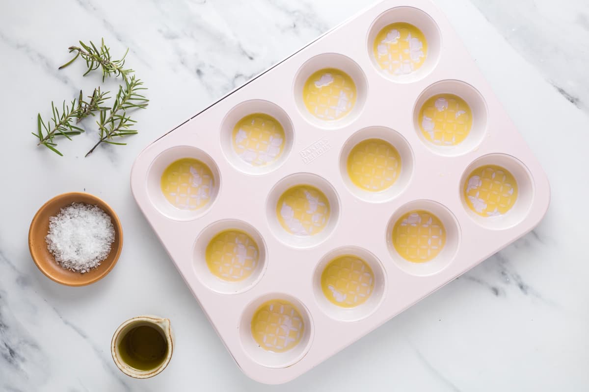 Muffin pan brushed with olive oil before adding sourdough focaccia dough.