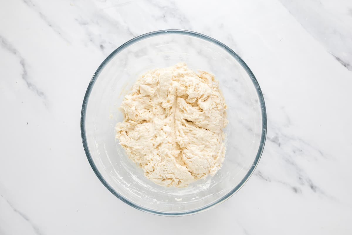 Shaggy sourdough focaccia dough after mixing ingredients before kneading and fermentation.