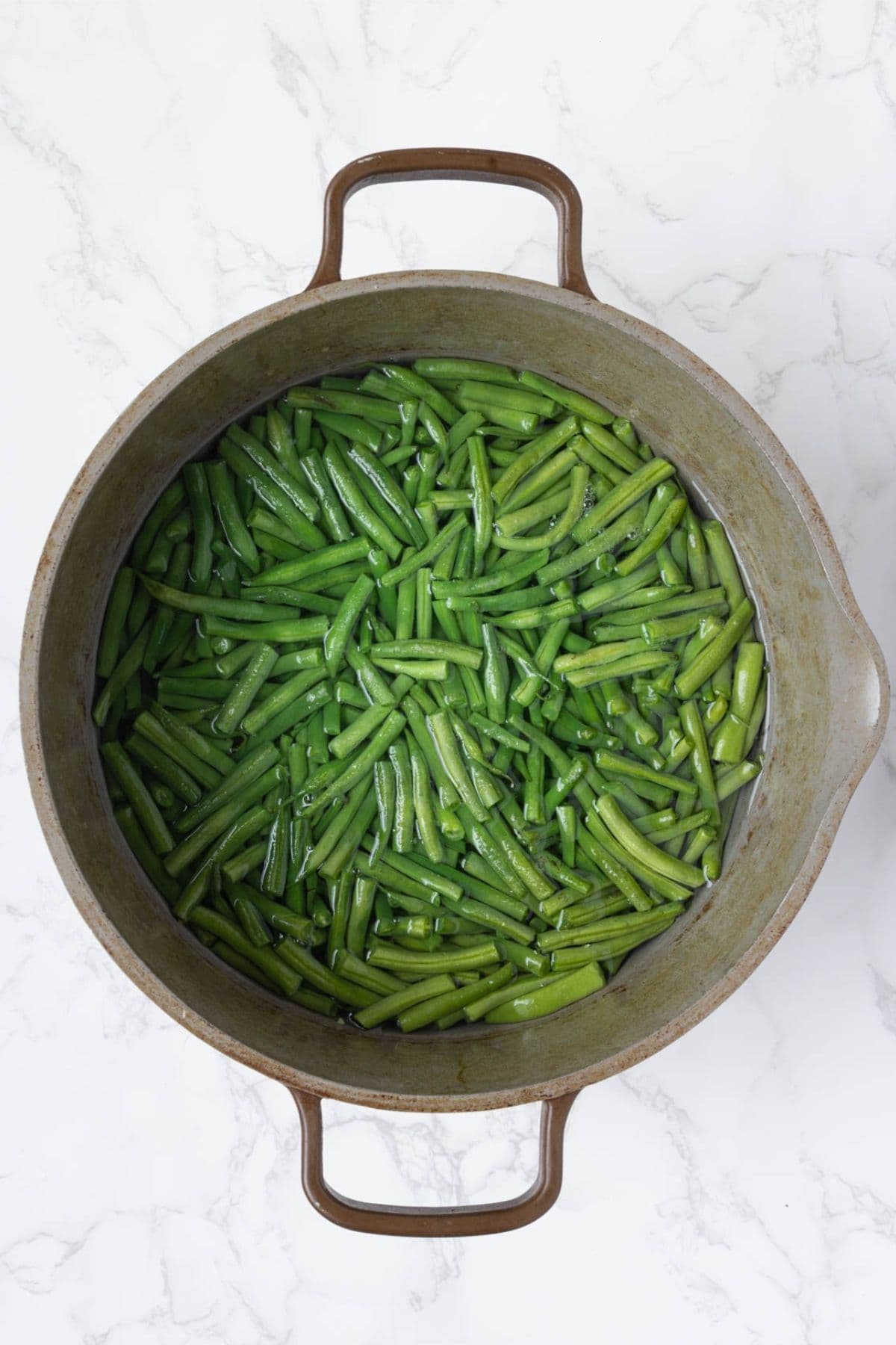 Fresh green beans blanching in boiling water before assembling green bean casserole.