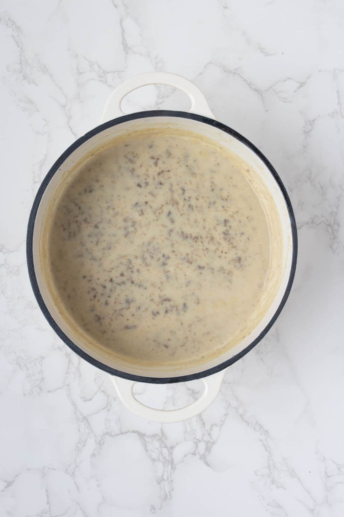 Creamy homemade mushroom sauce cooked for sourdough green bean casserole.