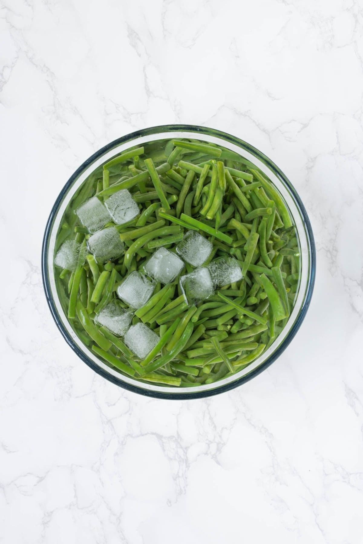 Fresh green beans cooling in an ice bath after blanching for sourdough green bean casserole.