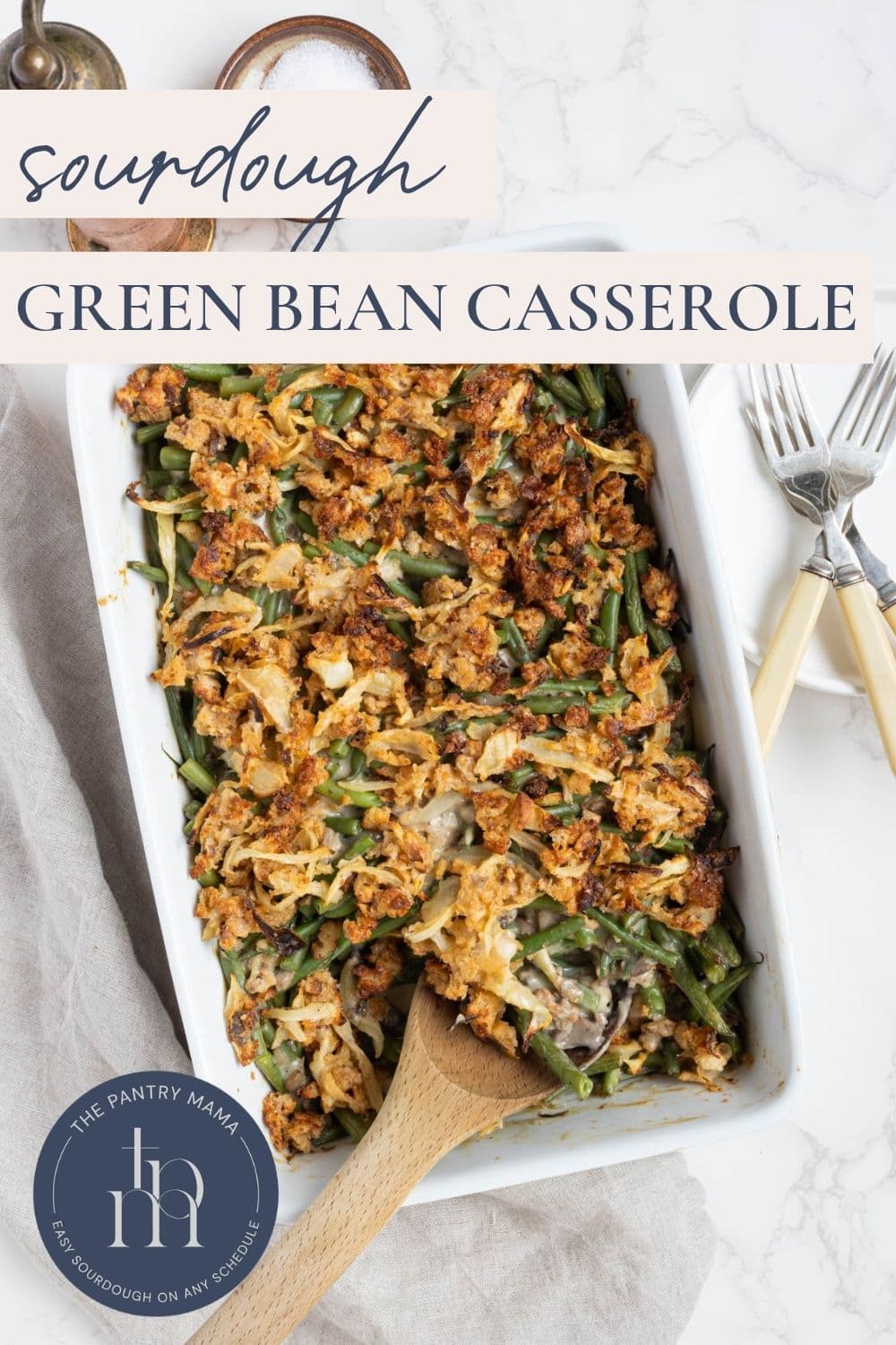 Sourdough green bean casserole baked until golden with homemade crispy onion topping in a baking dish.