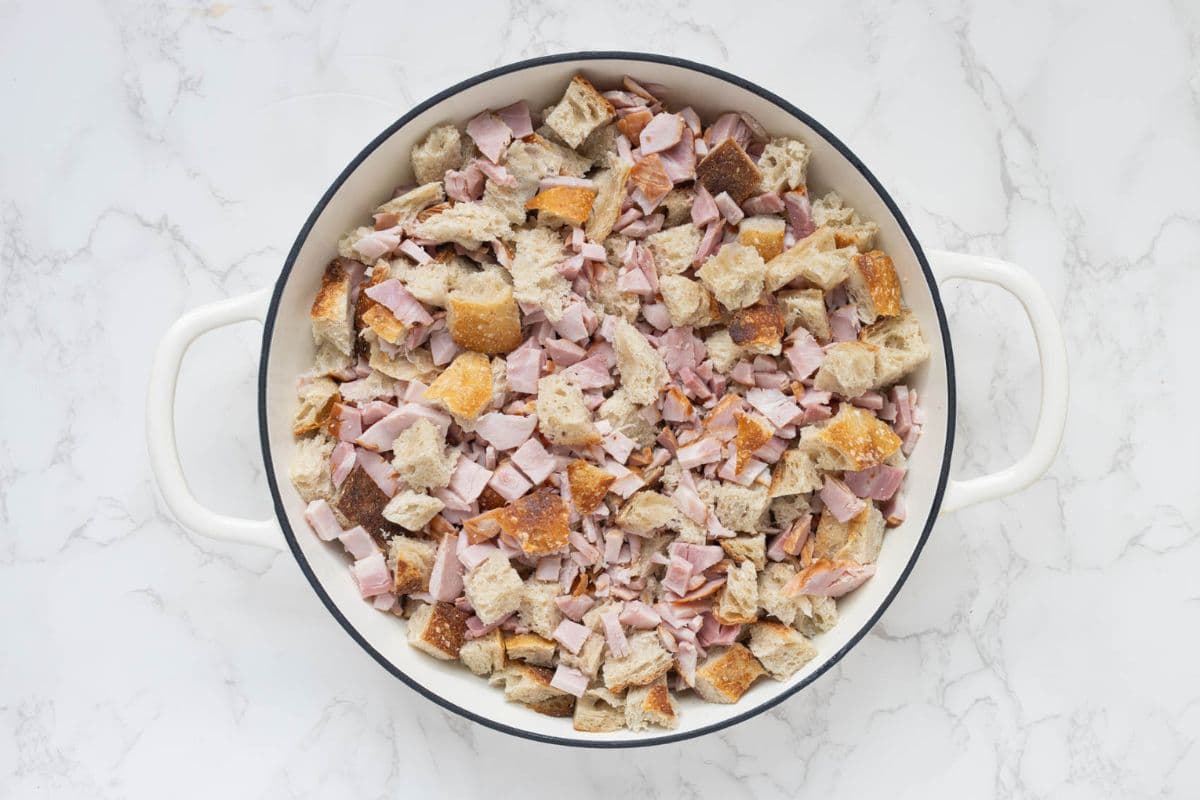 Sourdough bread cubes, diced ham and shredded cheese layered in a casserole dish before adding egg mixture.