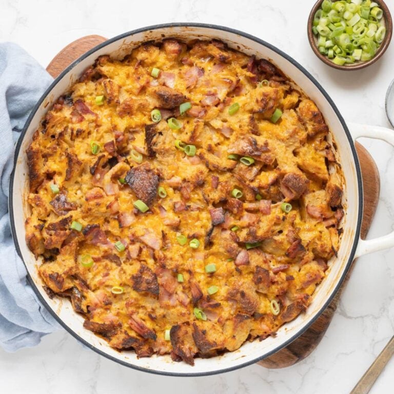 Freshly baked sourdough ham and cheese strata in a casserole dish ready to serve.