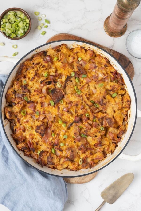 Overhead view of freshly baked sourdough ham and cheese strata in a casserole dish.