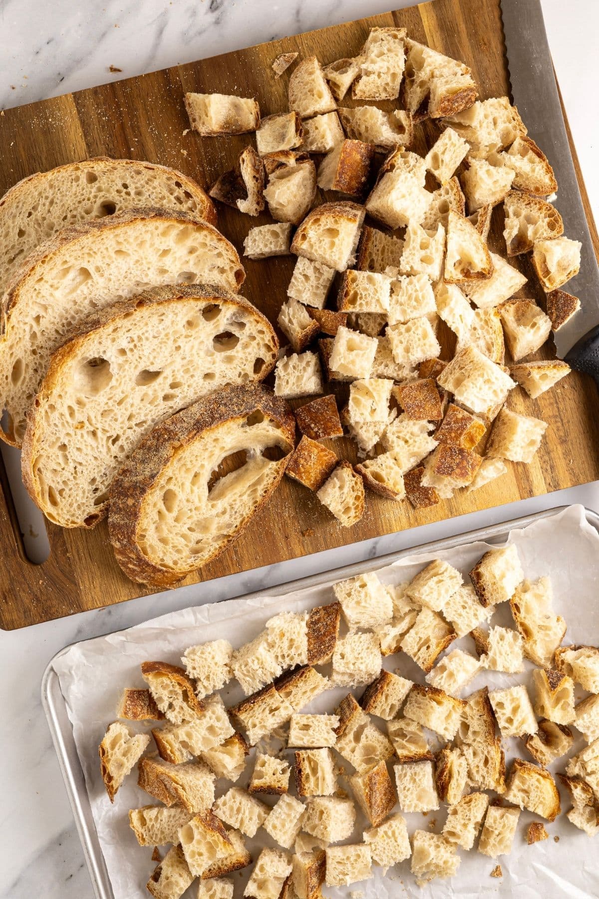 A vertical image showing how to cube sourdough bread cubes from a whole loaf of sourdough bread.