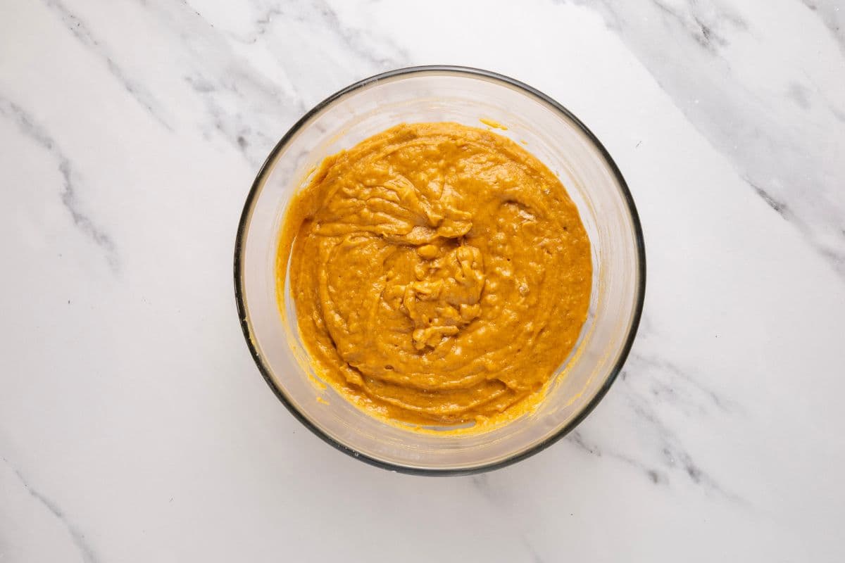 A glass bowl showing the finished batter for sourdough discard pumpkin bread recipe.