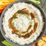 Close up of caramelized French onion dip topped with caramelized onions.