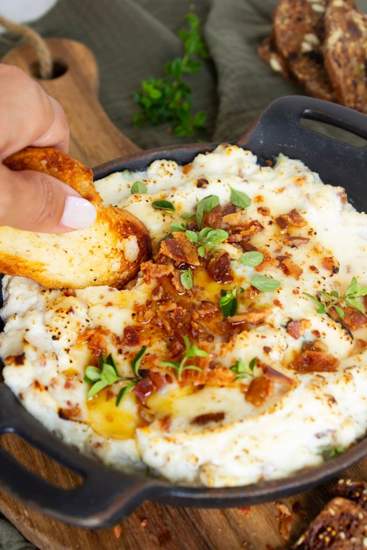 Baked ricotta dip with bacon and maple syrup served with sourdough crostini.