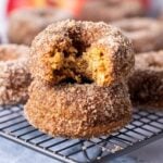 A close up image of sourdough apple cider donuts, showing the texture inside the donuts, as well as the cinnamon sugar exterior.