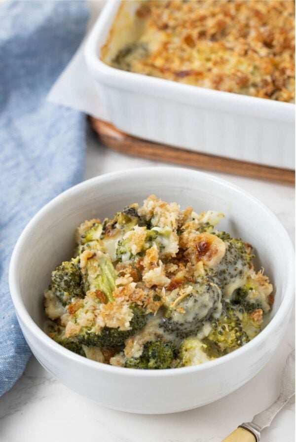 Bowl of creamy sourdough broccoli casserole with tender broccoli florets, cheese sauce, and a golden sourdough breadcrumb topping.