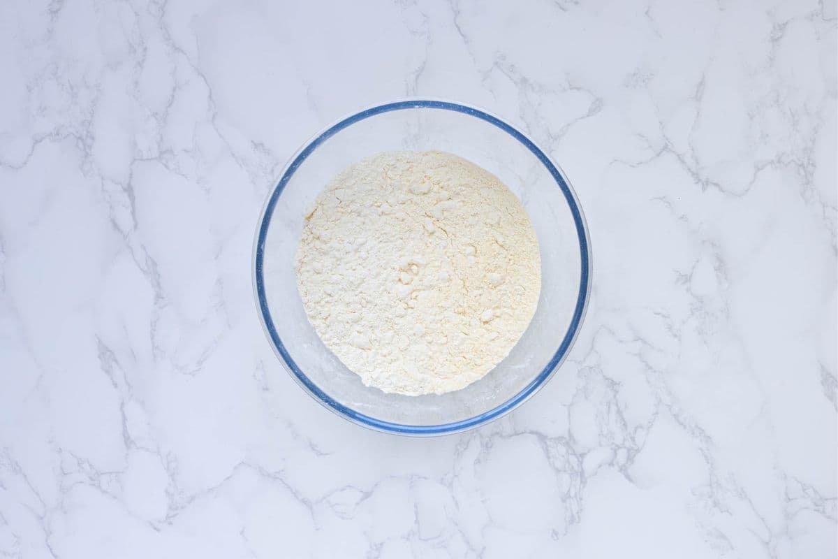 A bowl of flour that has had butter rubbed into it.