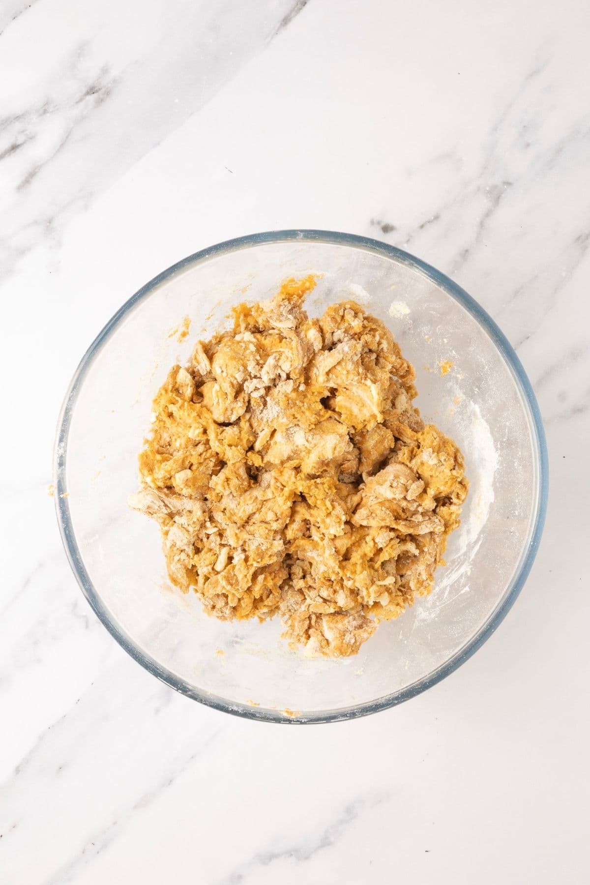 A glass bowl showing the finished sourdough pumpkin scone dough.