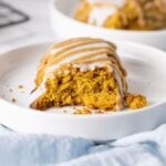 Close up image of a sourdough pumpkin scone with double glaze.