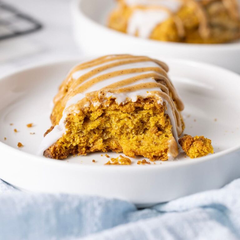 Close up image of a sourdough pumpkin scone with double glaze.